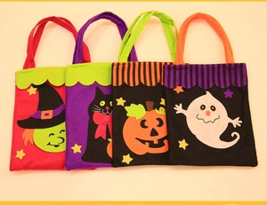 Four Halloween non-woven gift bags featuring witch, cat, pumpkin, and ghost designs