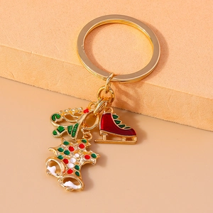 Detailed shot of Christmas tree, ice skate and bell charms on a golden alloy keychain