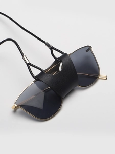 Detail of black faux leather sunglass holder with litchi texture and neck strap cord
