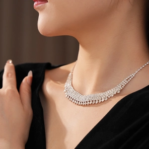 Detail of silver rhinestone fringe necklace worn on neck for formal events