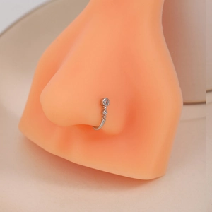 U-shaped non-pierced silver nose cuff with sparkling rhinestones on a silicone model