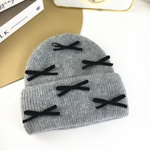 Gray knitted beanie for women featuring six black velvet bows for a sweet autumn look