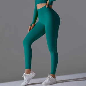 Detail of high waist teal yoga leggings and long sleeve crop top with thumbholes