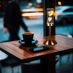 Preserved flower acrylic bedside lamp with gold metal base on table for cozy atmosphere