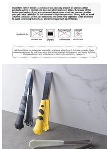 Detailed view of cat paw food tongs in black, yellow and white with non-slip grips