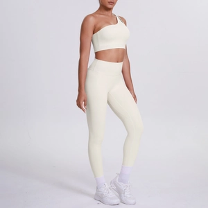Side view of cream one-shoulder sports bra and high-waisted yoga leggings set
