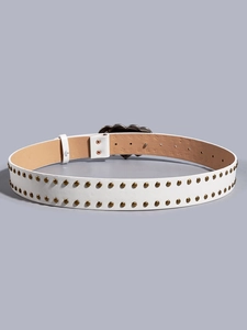 Detail of white faux leather belt with gold round studs and silver heart-shaped buckle