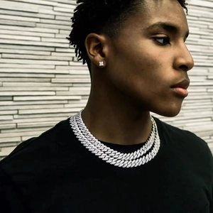 Silver 14mm iced out Cuban chain necklace and matching square stud earrings on male model