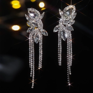 Macro shot of silver bow tassel earrings with sparkling marquise and drop rhinestones