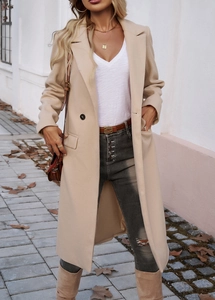 Detail of a chic beige long coat with double-breasted buttons in a street style setting