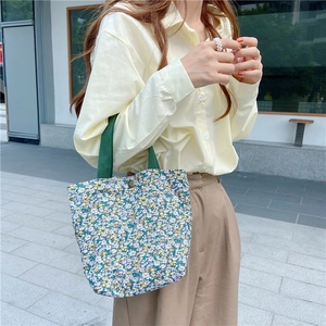 Floral canvas mini tote bag with green ribbon handles and snap button closure for casual wear