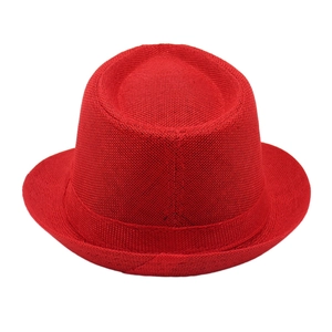 Macro shot of red woven Trilby hat showing textured paper straw pattern and band