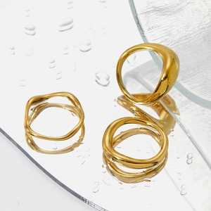 Three-piece stackable gold stainless steel ring set with irregular wavy minimalist design