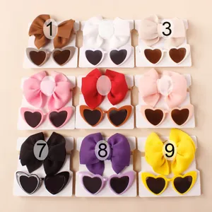 Macro view of 9-color baby bow headband and heart-shaped sunglasses accessory sets