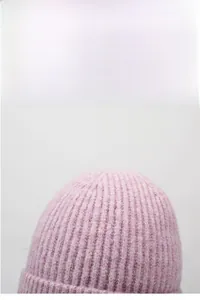 Close-up of pink knitted beanie showing vertical rib texture and warmth detail