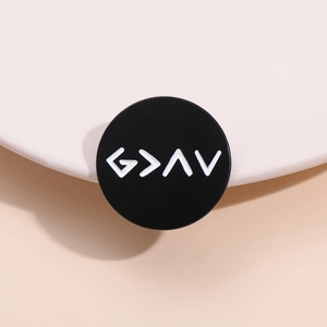 Minimalist black enamel brooch pin featuring white G > ^ V symbols in a metal circle