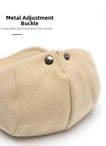 Macro detail of the wool beret showing the metal buckle for adjustable head circumference