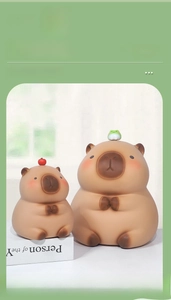 Λεπτομερής όψη κουμπαρά Capybara με βάτραχο και μήλο μαζί με συσκευασία δώρου
