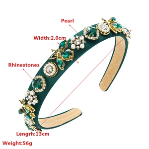 Detail of green velvet headband featuring crystal bees and faux pearl flower embellishments