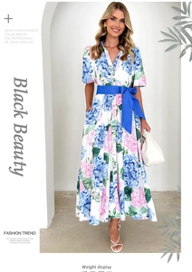 Close-up of floral print A-line dress featuring blue waist belt and pink flower details