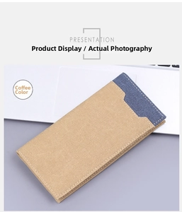 Close-up of slim coffee canvas long wallet with blue stitching detail on a laptop