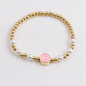 Golden beads and pearls bracelet with a pink enamel 'C' letter pendant for women