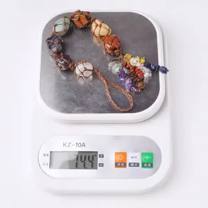 Macro detail of natural seven chakra gemstones woven wall hanging decoration weighing 144g
