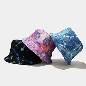 Detail view of three reversible bucket hats with fishbone and ocean animal patterns