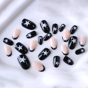 Classic black and pink French press-on nails with white stars in short oval shape