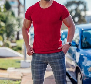 Close-up of red slim fit men's T-shirt featuring vertical ribbed texture and elastic fabric