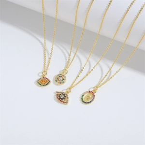 Gold evil eye and religious pendant necklaces set with colorful zircon stones