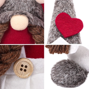 Detail of plush gnome with artificial grey fur, red felt heart and a rustic wood button