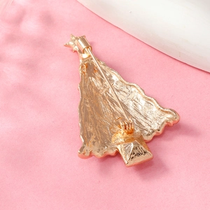 Detail view of the golden Christmas tree brooch back showing the pin closure mechanism