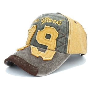 Detailed embroidery of 'New York' and frayed '79' patch on a vintage denim baseball cap