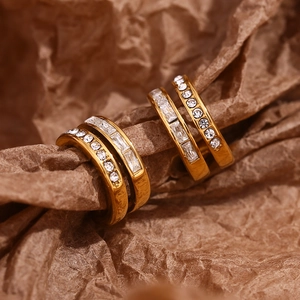 Macro shot of 18K gold plated double-layer C-shape hoop earrings with inlaid zircons