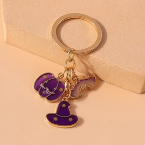 Detail of Halloween keychain with purple enamel pumpkin, bat and wizard hat charms
