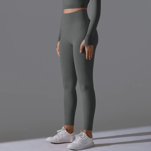 Detail of grey-green seamless high waist yoga leggings and thumbhole sleeves
