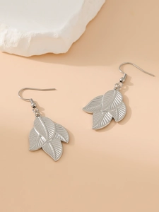 Detailed view of silver leaf pendant earrings with realistic metal textures and ear hooks