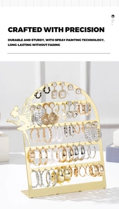 Detail of fairy silhouette metal earring organizer with a gold-painted finish