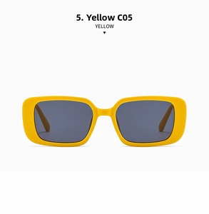 Detail view of bold yellow rectangular sunglasses frames with dark gray lenses