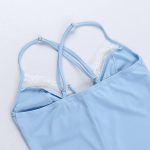 Detail of light blue lace mini dress showing adjustable cross-back straps and silver buckle