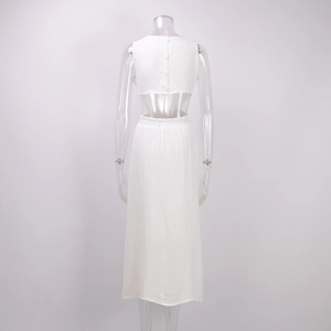 Detailed back view of white two-piece set featuring textured fabric and button closure