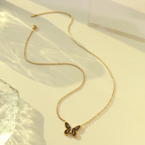 Bohemian gold plated titanium necklace with black enamel butterfly pendant on glass