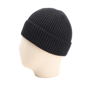 Close-up of black ribbed knit beanie showing vertical stripe texture and fold-over cuff