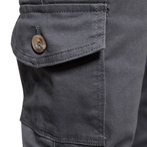 Detail of dark grey cargo pants showing flap pocket, twill fabric and button closure