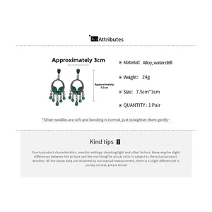 Detailed view of emerald tassel drop earrings with dimensions and material specifications