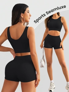 Detail of seamless black yoga set with ribbed texture on sports bra and high waist shorts