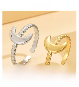 Detailed view of moon-shaped open rings in polished gold and silver finishes