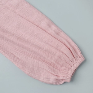 Detail of pink puff lantern sleeve with elastic cuff and pleated texture fabric