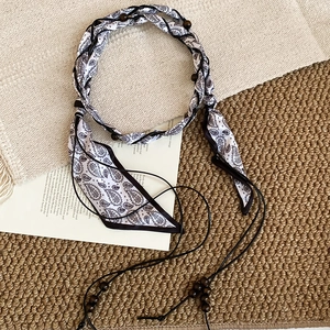 Détail de la chaîne de taille en ruban de soie paisley avec perles en bois brun